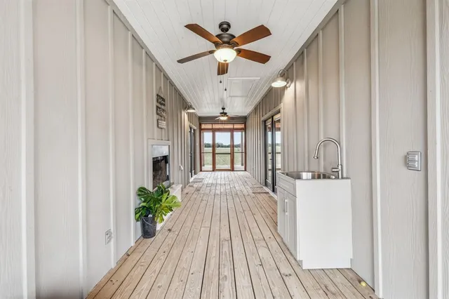 a view of living room with wooden floor and ceiling fan