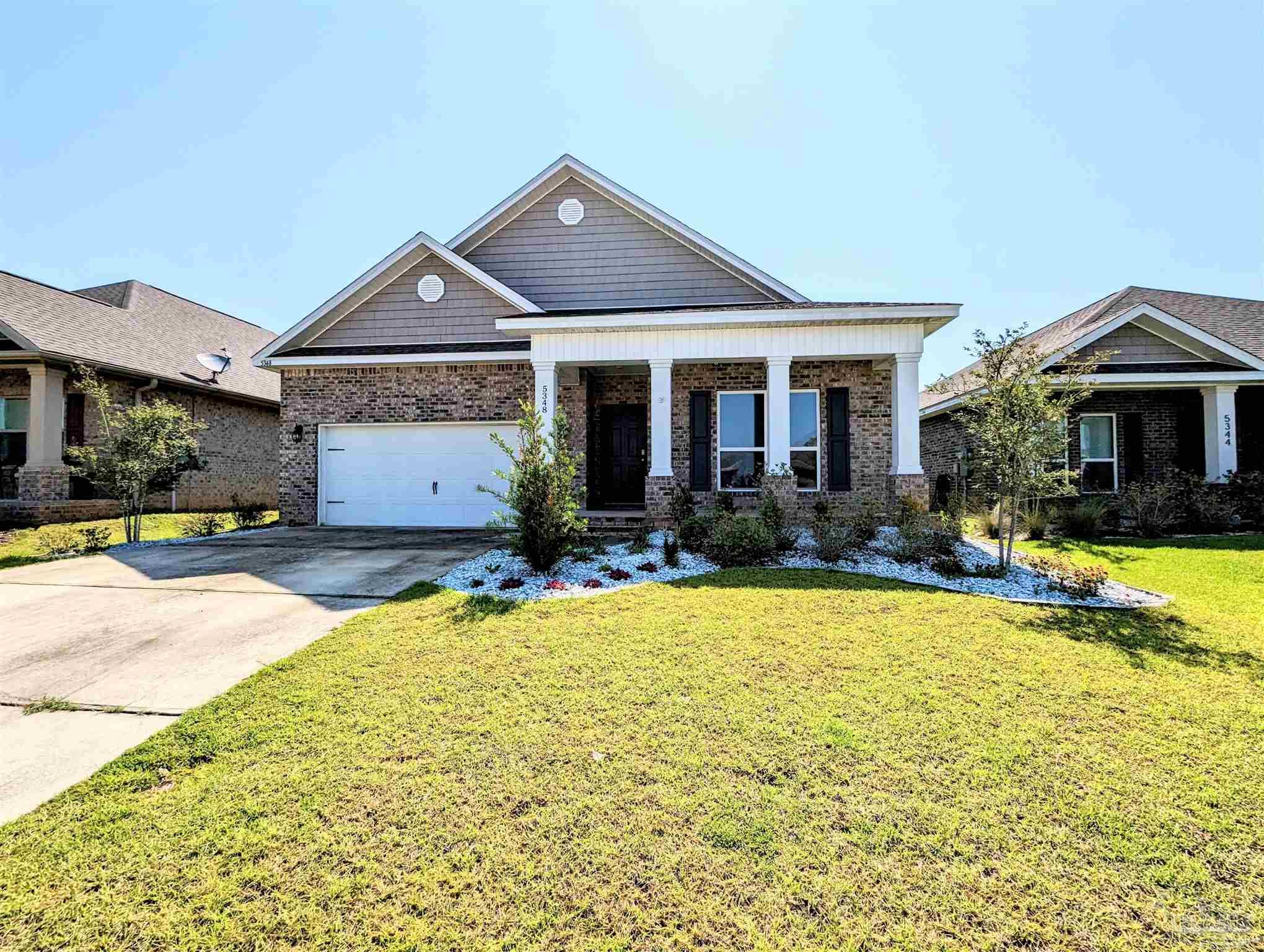 5348 Red Shoulder Road Pace, FL 32571 - Photo 2 of 39 a front view of a house with swimming pool