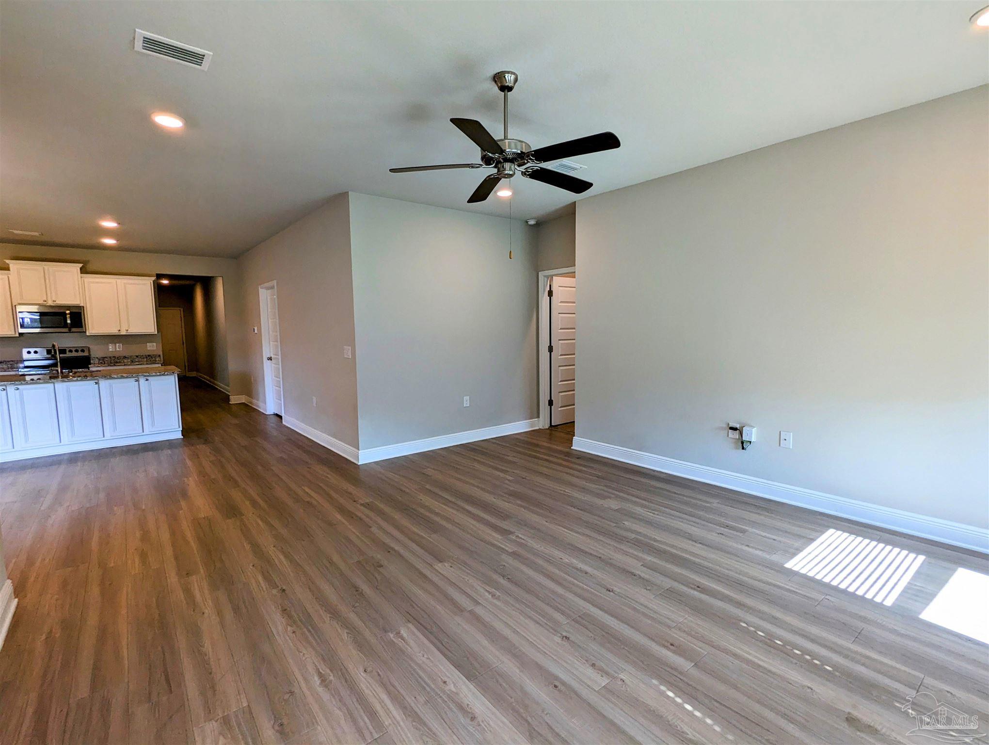 5348 Red Shoulder Road Pace, FL 32571 - Photo 25 of 39 a view of a kitchen with a sink and wooden floor