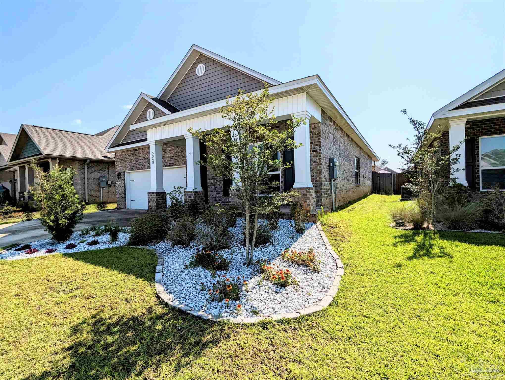 5348 Red Shoulder Road Pace, FL 32571 - Photo 4 of 39 a view of a house with backyard and sitting area