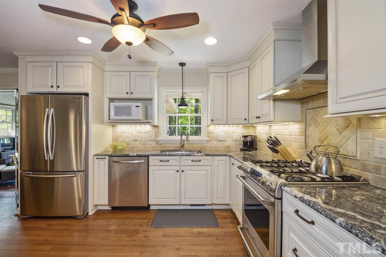 3701 Dade Street Raleigh, NC 27612 - Photo 1 of 23 Large open renovated kitchen with granite countertops, beautiful cabinets, and stainless steel appliances