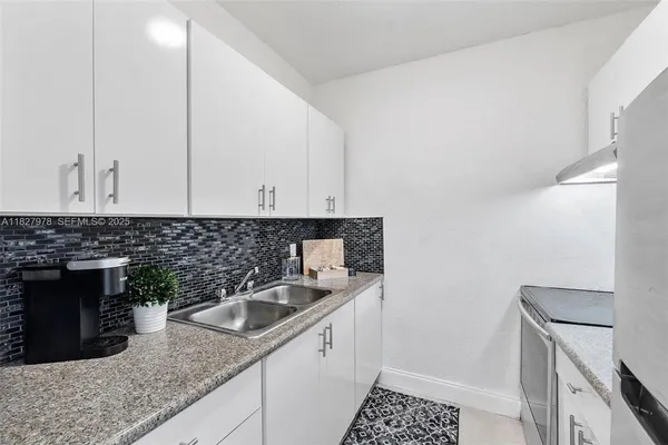 a kitchen with a sink and cabinets
