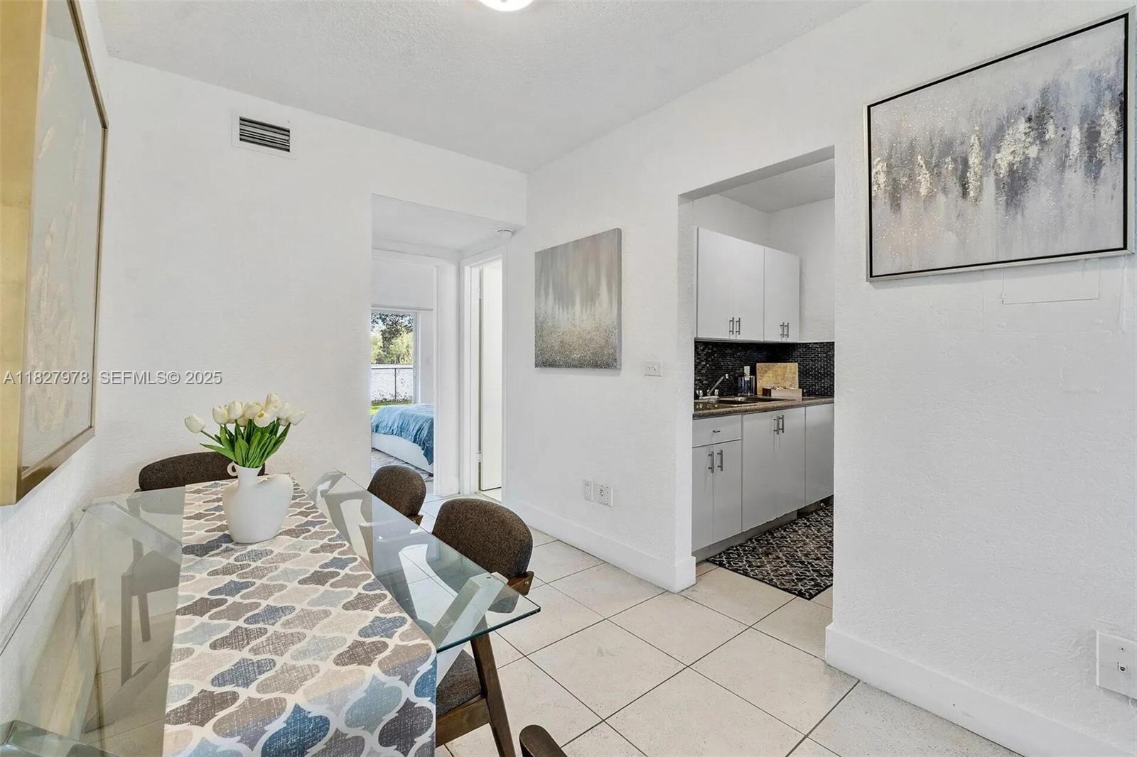 1401 Northwest 103rd Street, Unit 139 Miami, FL 33147 - Photo 5 of 11 a living room with furniture and flowers