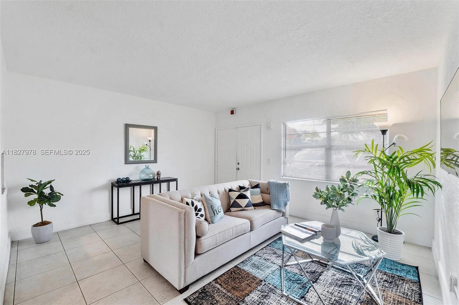 1401 Northwest 103rd Street, Unit 139 Miami, FL 33147 - Photo 6 of 11 a living room with furniture and a potted plant