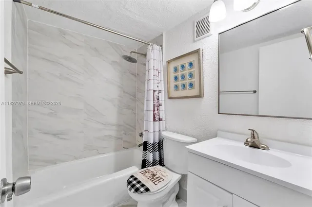 a bathroom with a sink a mirror and a bathtub