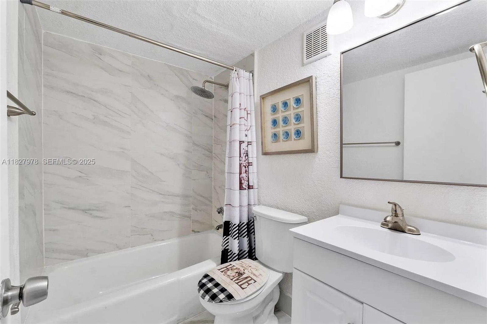 1401 Northwest 103rd Street, Unit 139 Miami, FL 33147 - Photo 8 of 11 a bathroom with a sink a mirror and a bathtub