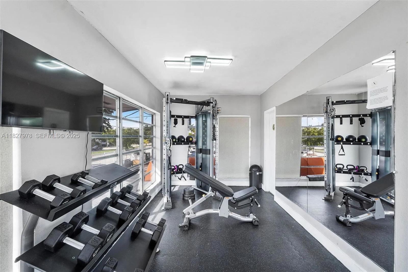 1401 Northwest 103rd Street, Unit 139 Miami, FL 33147 - Photo 10 of 11 a view of a room with gym equipment