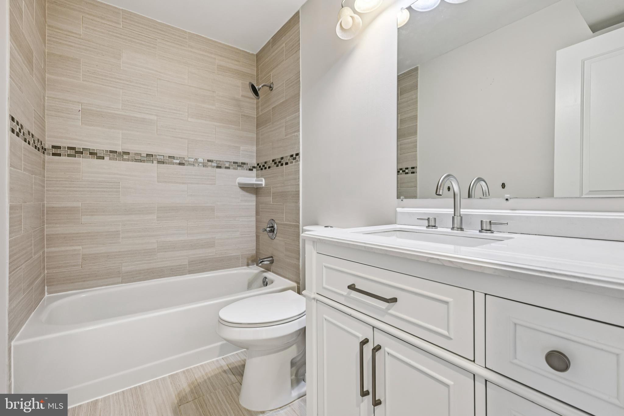 14901 Cleese Court, Unit 5CE Silver Spring, MD 20906 - Photo 18 of 25 a bathroom with a sink a toilet and a bathtub