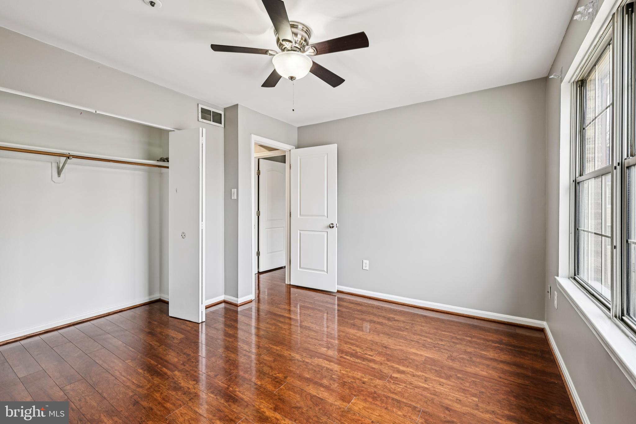 14901 Cleese Court, Unit 5CE Silver Spring, MD 20906 - Photo 22 of 25 wooden floor in an empty room with a window