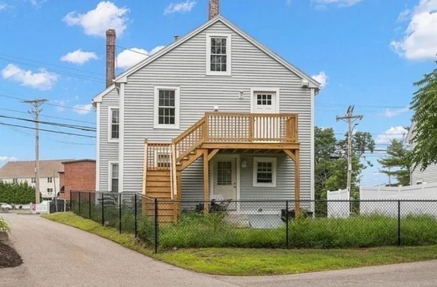 199 Andover Street, Unit 1 Andover, MA 01810 - Photo 13 of 16 a front view of a house with a yard