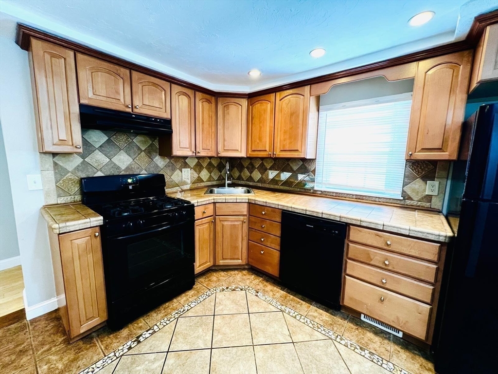 199 Andover Street, Unit 1 Andover, MA 01810 - Photo 3 of 16 a kitchen with a sink stove and refrigerator