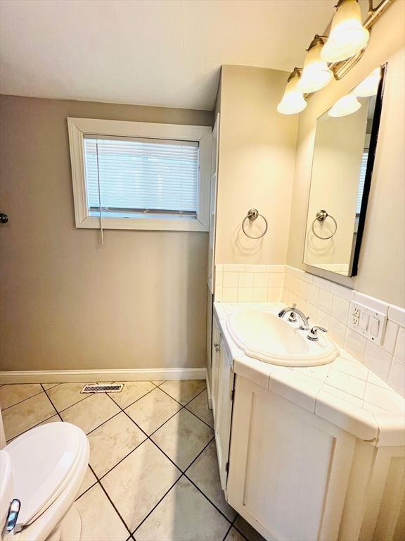199 Andover Street, Unit 1 Andover, MA 01810 - Photo 10 of 16 a bathroom with a sink and a mirror