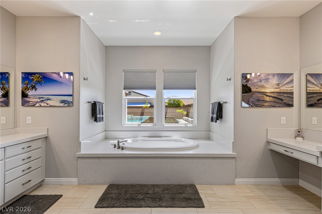 7036 Arabian Ridge Street Las Vegas, NV 89131 - Photo 29 of 64 Spa-inspired ensuite featuring a separate soaking tub, walk-in shower, and dual sinks and vanities.