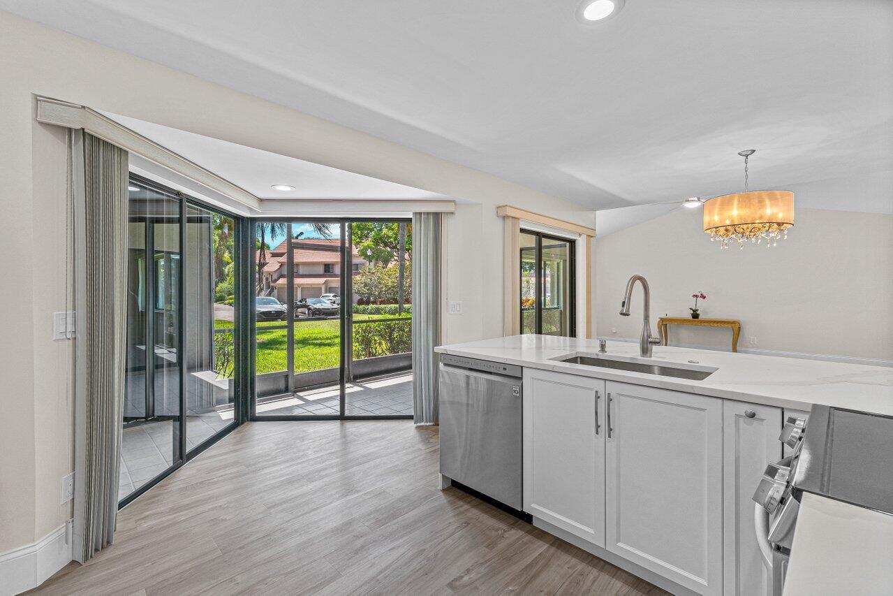 5560 Coach House Circle, Unit B Boca Raton, FL 33486 - Photo 12 of 30 KITCHEN OPENS TO PATIO