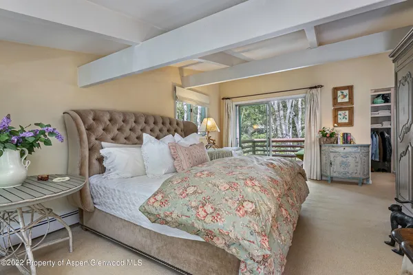 a bedroom with a large bed and potted plant