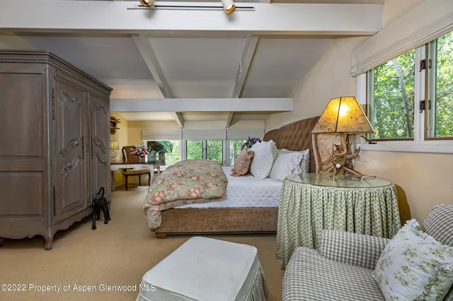 a living room with furniture and a lamp