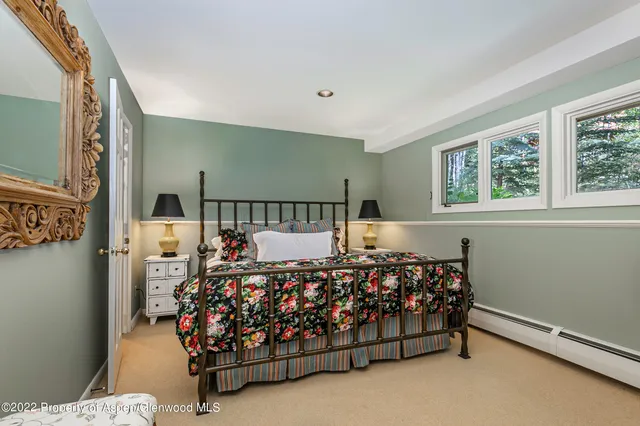 a bed sitting in a bedroom next to a window