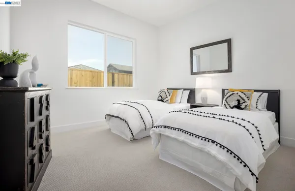 a bedroom with a bed and painting on the wall