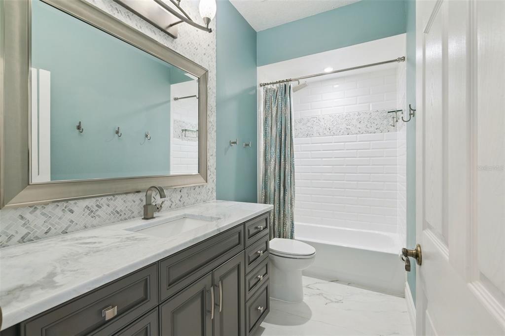 2230 Ridgewind Way Windermere, FL 34786 - Photo 23 of 38 a bathroom with a granite countertop sink toilet and shower