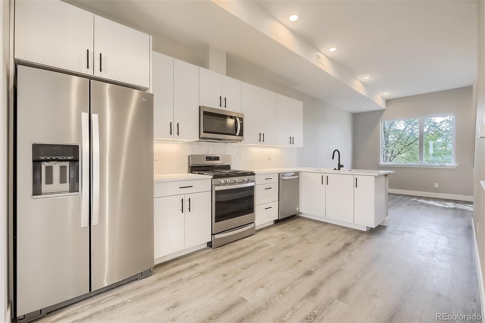 3820 Jason Street, Unit 6 Denver, CO 80211 - Photo 14 of 36 a kitchen with stainless steel appliances a refrigerator sink and cabinets