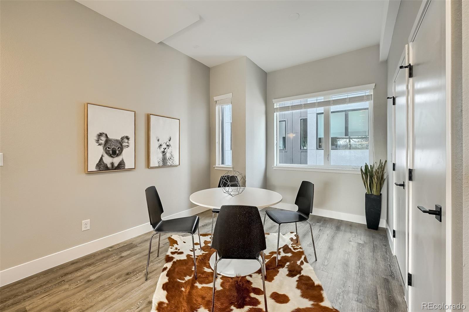 3820 Jason Street, Unit 6 Denver, CO 80211 - Photo 19 of 36 a dining room with wooden floor and a chandelier