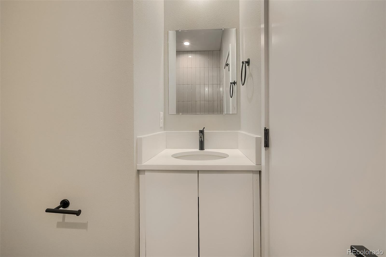 3820 Jason Street, Unit 6 Denver, CO 80211 - Photo 21 of 36 a bathroom with a sink and a mirror