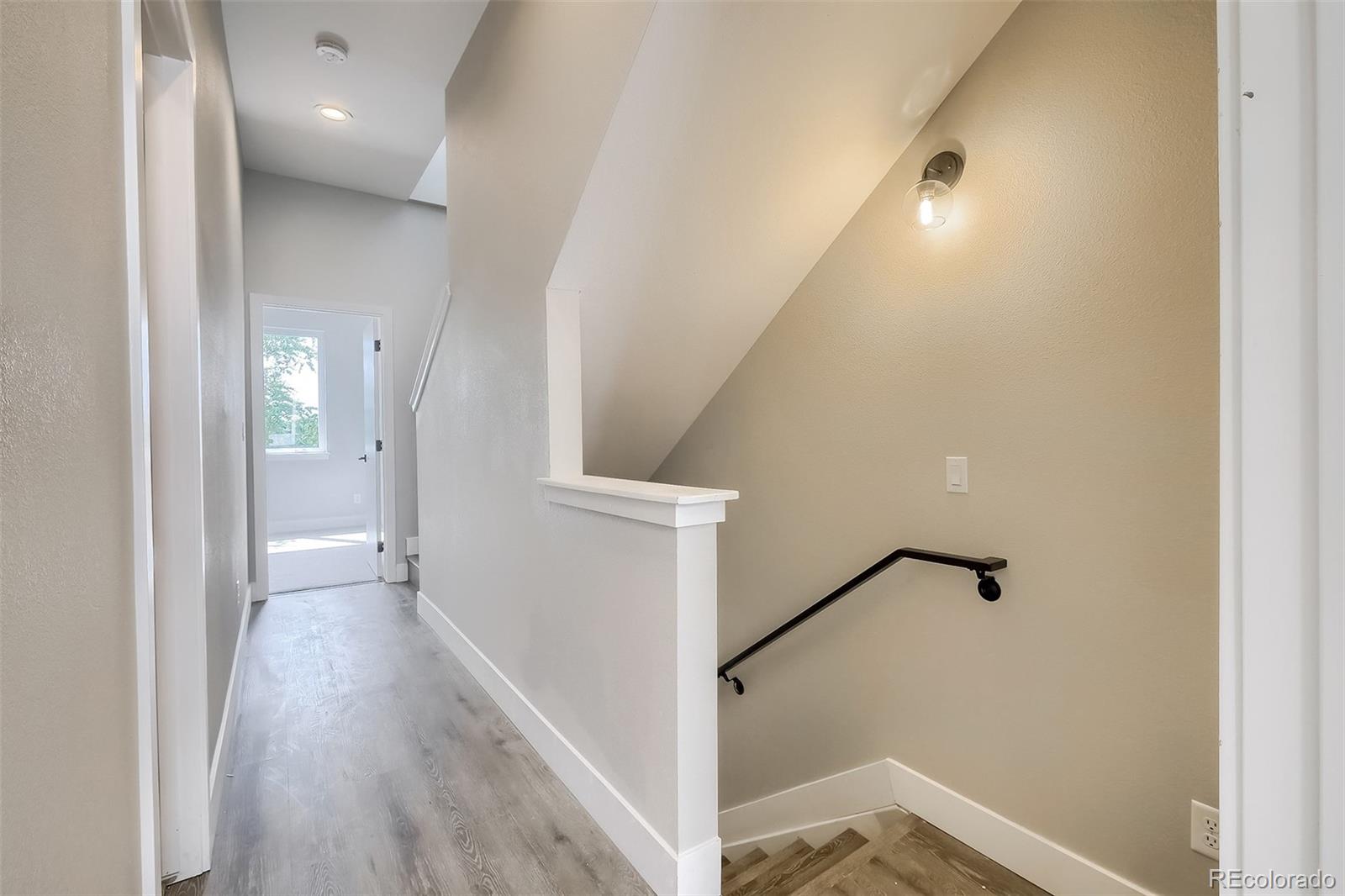 3820 Jason Street, Unit 6 Denver, CO 80211 - Photo 22 of 36 a view of a hallway with wooden floor and staircase