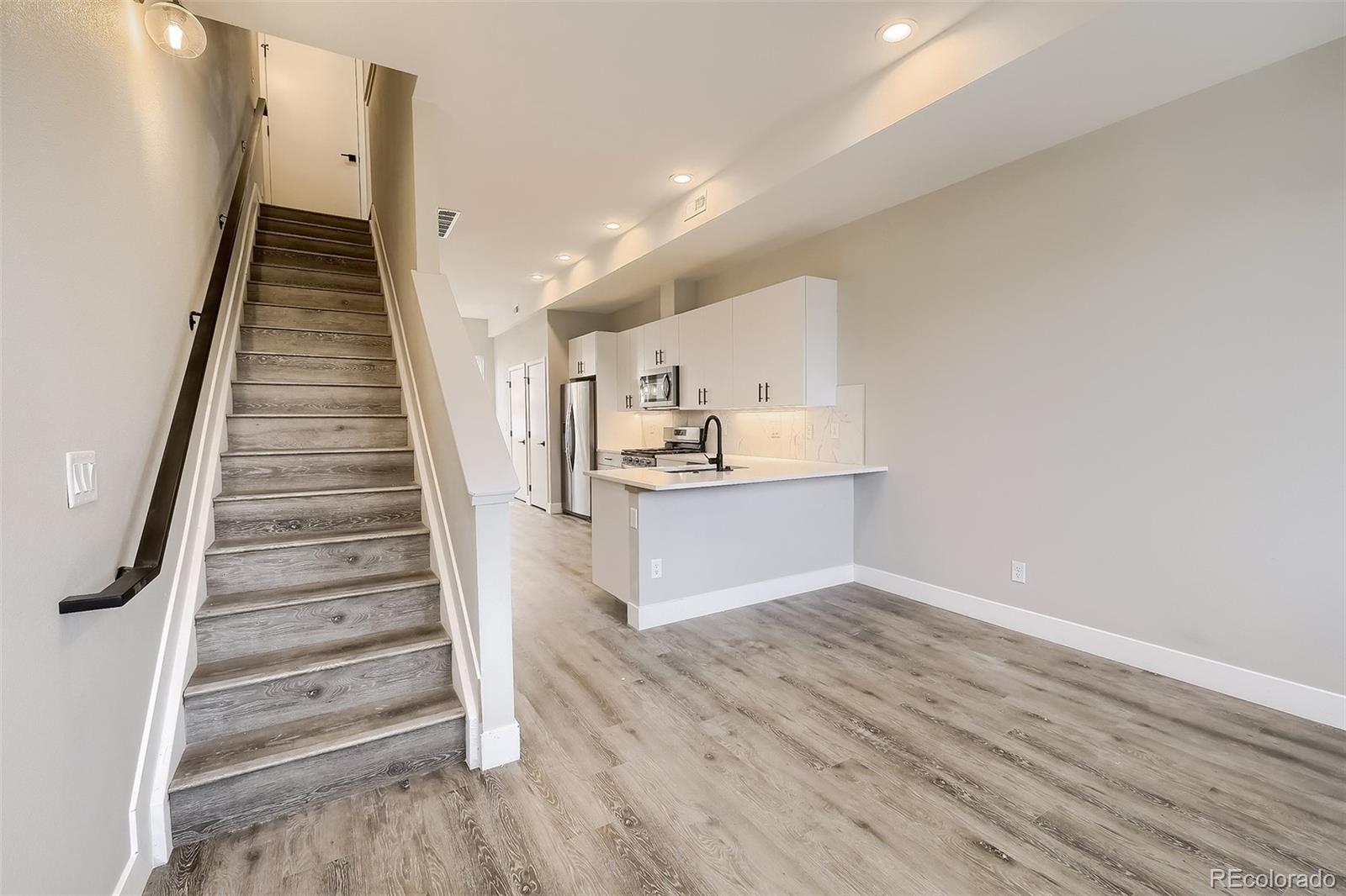 3820 Jason Street, Unit 6 Denver, CO 80211 - Photo 8 of 36 a view of kitchen and hall with wooden floor