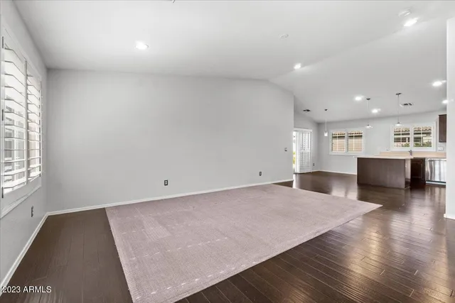 a view of kitchen and hall with wooden floor