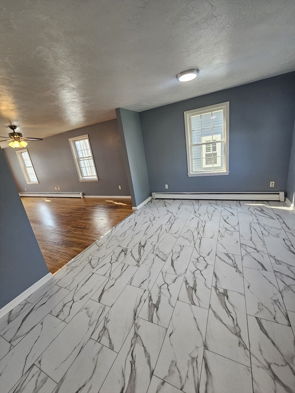 40 Merrick Street, Unit A Worcester, MA 01609 - Photo 29 of 32 a view of a room with a bed and wooden floor