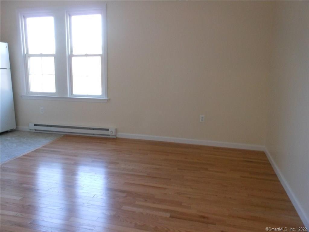 277 Whisconier Road, Unit B Brookfield, CT 06804 - Photo 3 of 10 an empty room with wooden floor and windows