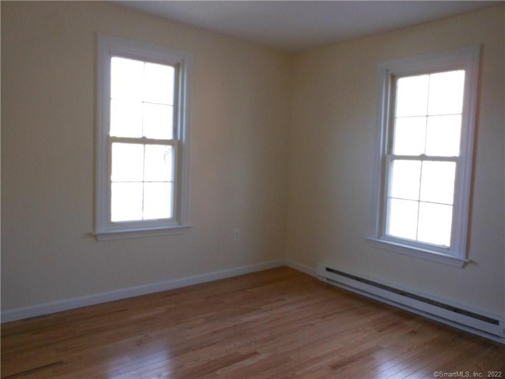277 Whisconier Road, Unit B Brookfield, CT 06804 - Photo 5 of 10 an empty room with wooden floor and windows