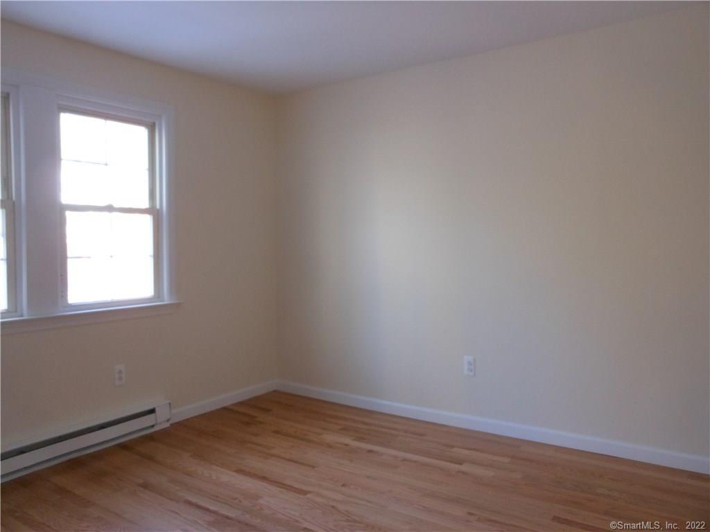 277 Whisconier Road, Unit B Brookfield, CT 06804 - Photo 6 of 10 an empty room with wooden floor and windows