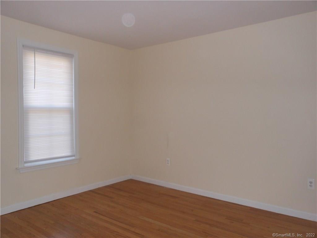 277 Whisconier Road, Unit B Brookfield, CT 06804 - Photo 7 of 10 an empty room with wooden floor and windows