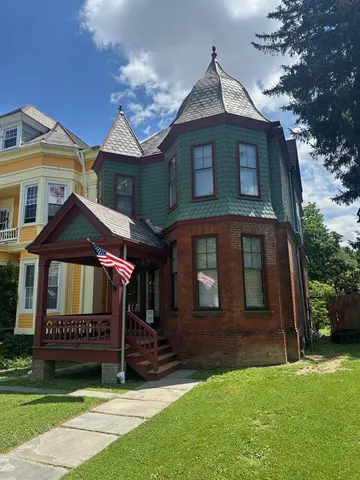 a front view of a house with a garden