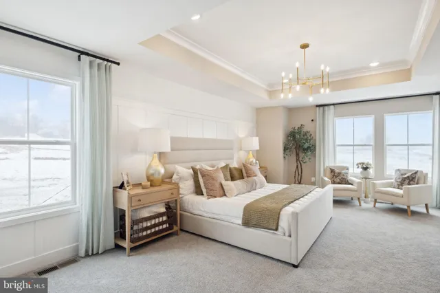 a bathroom with a double vanity sink a mirror and a bathtub
