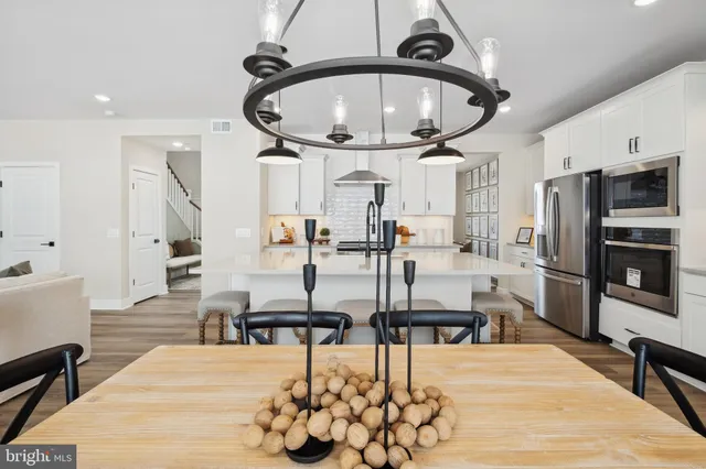 a dining room with furniture window and wooden floor