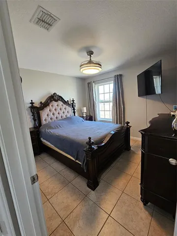 a bedroom with a bed and a tv