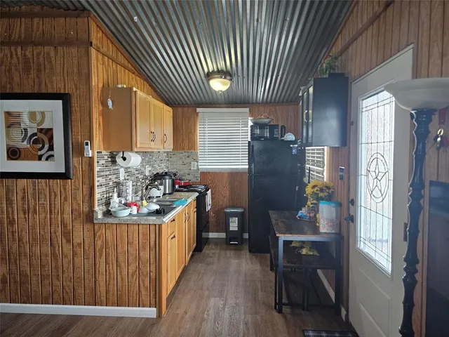 a kitchen with stainless steel appliances granite countertop a refrigerator and a stove