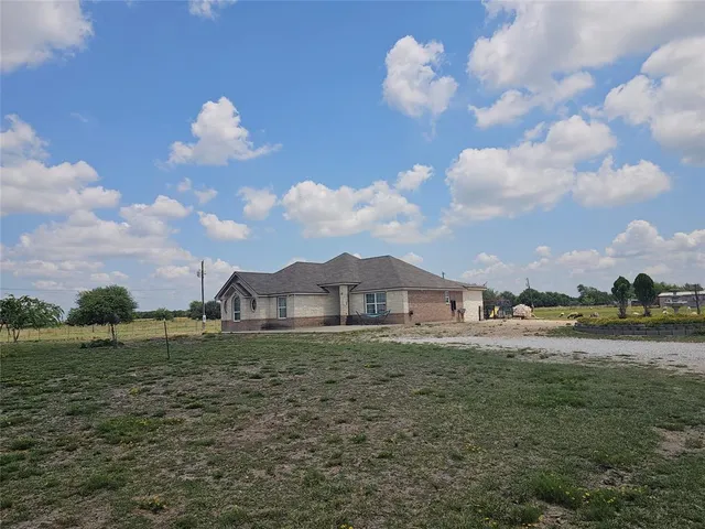 a view of a yard with a house and a garden