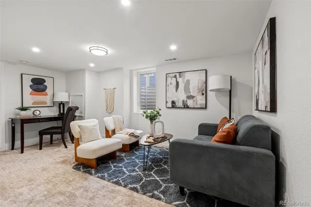a living room with furniture and a rug
