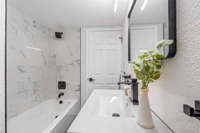 a bath tub sitting next to a white sink