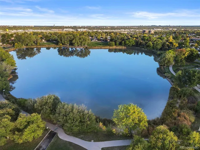 an aerial view of ocean and residential houses with outdoor space