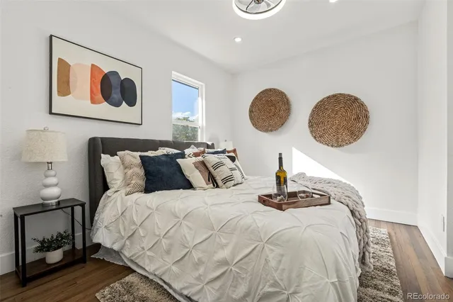 a bedroom with bed and a painting