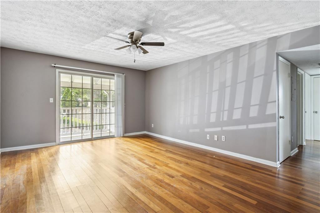 3155 Seven Pines, Unit 303 Atlanta, GA 30339 - Photo 4 of 25 a view of an empty room with wooden floor and a window