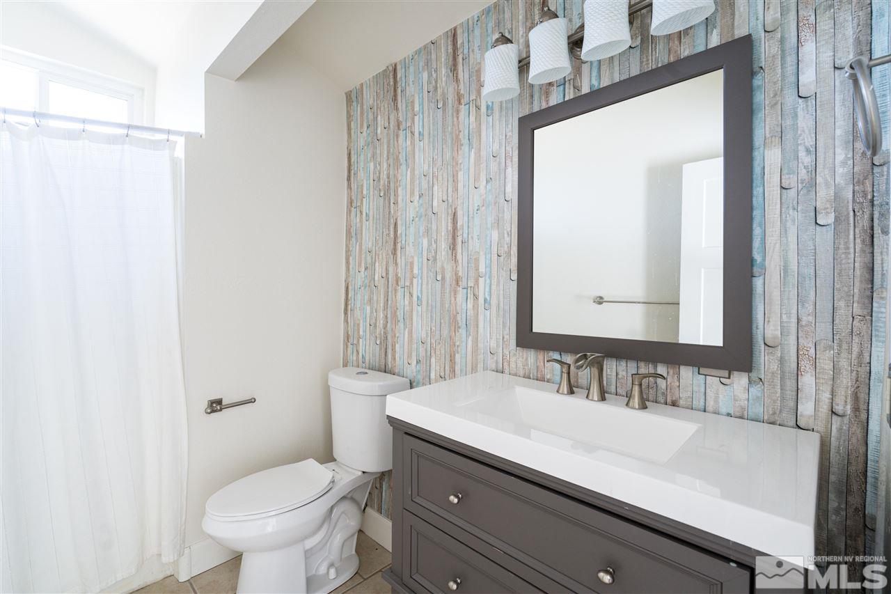 3975 Lamay Lane Reno, NV 89511 - Photo 11 of 28 a bathroom with a sink a toilet and a mirror