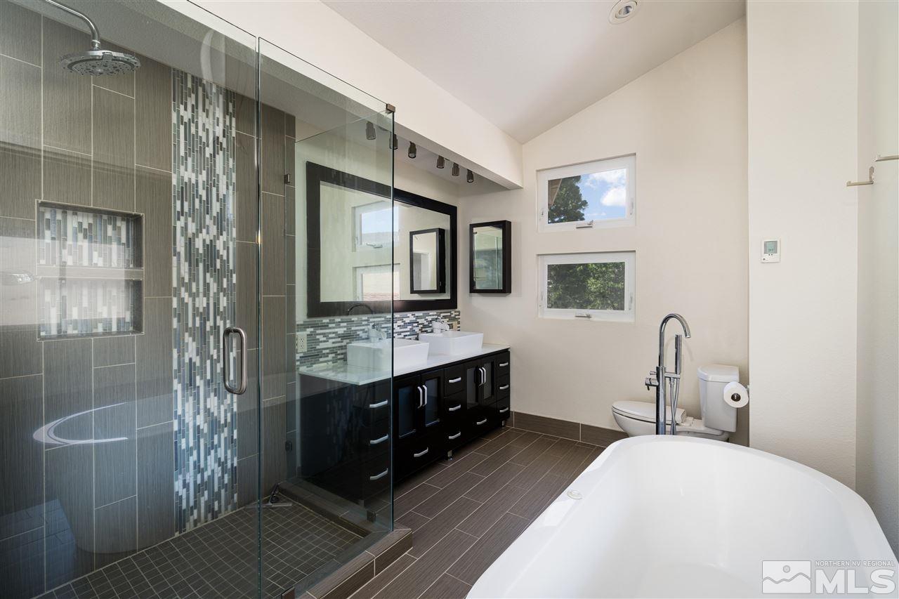 3975 Lamay Lane Reno, NV 89511 - Photo 13 of 28 a spacious bathroom with a double vanity sink a mirror and shower