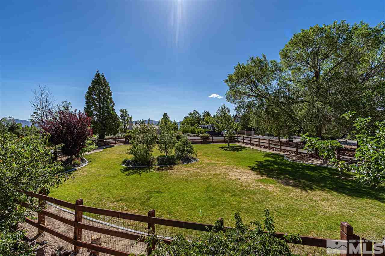 3975 Lamay Lane Reno, NV 89511 - Photo 4 of 28 a view of a swimming pool with lawn chairs under an umbrella