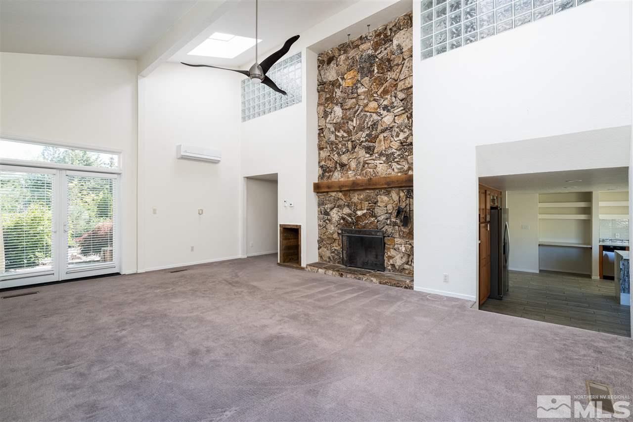3975 Lamay Lane Reno, NV 89511 - Photo 10 of 28 an empty room with fireplace and windows