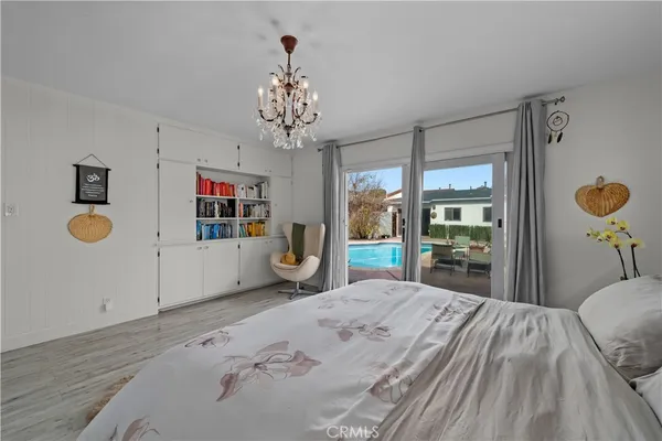 a bedroom with a bed and dresser with mirror